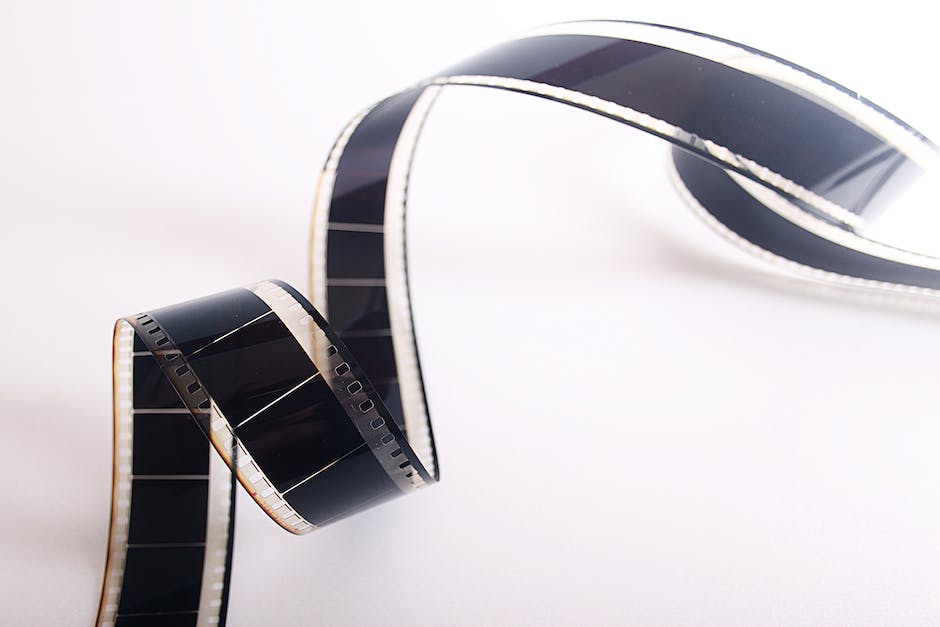 A visual representation of the evolution of cinema, showing a film reel transitioning into a digital film reel.