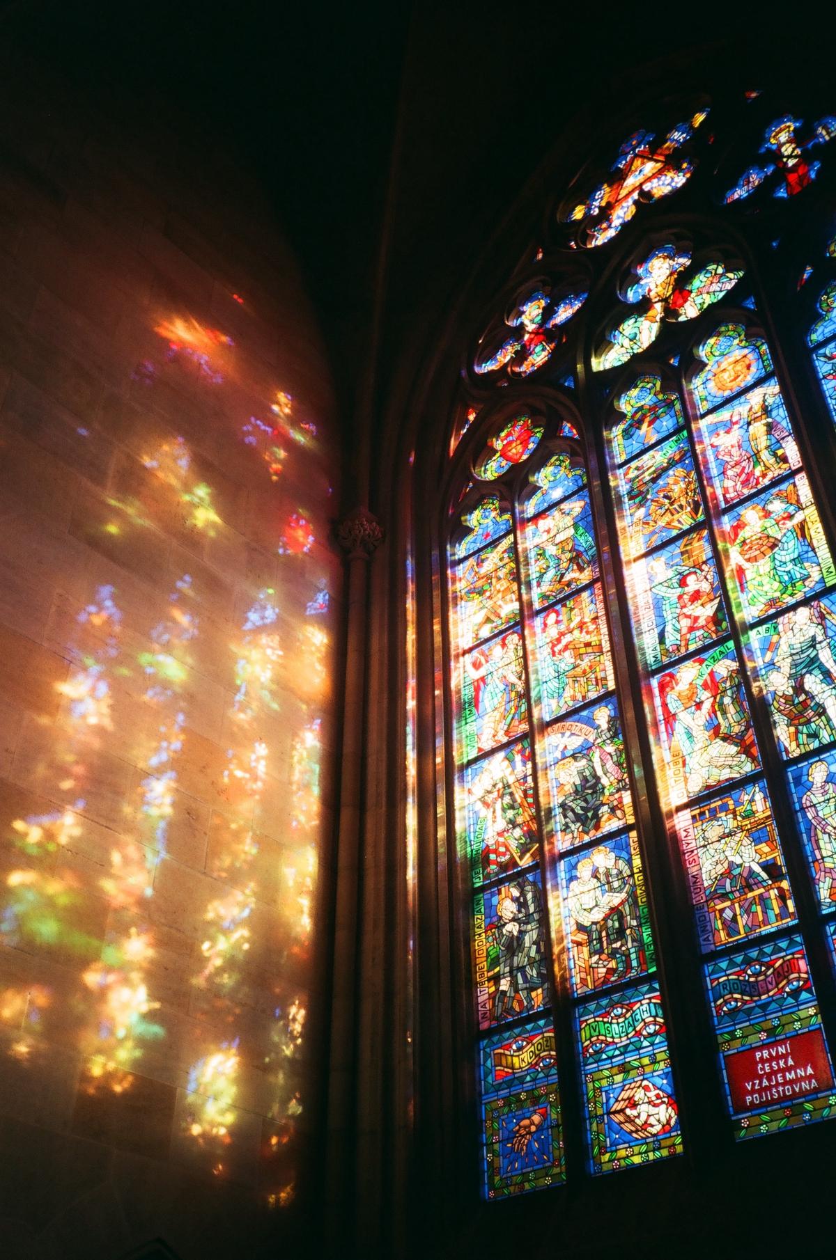 stained glass window in a Gothic Cathedral depicting religious figures and scenes, showcasing the intricate details and vibrant colors