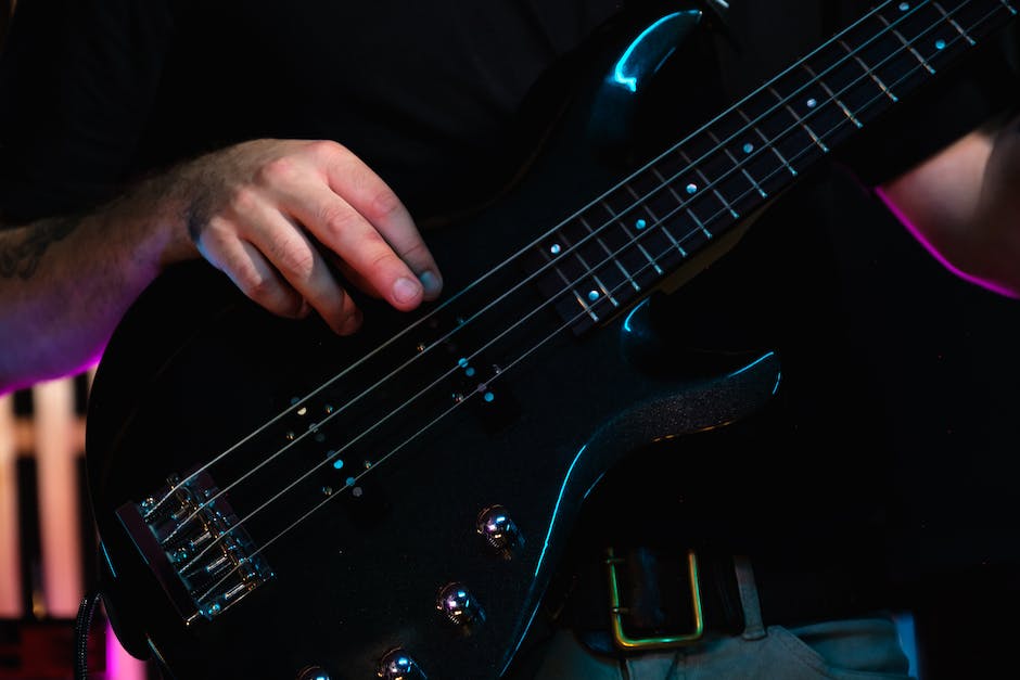 Tye Trujillo performing on stage with a bass guitar, showcasing his passion and talent for music.